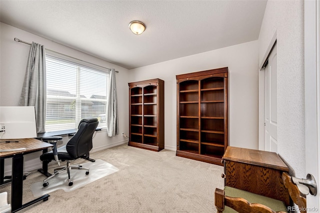 office space with light carpet and a textured ceiling