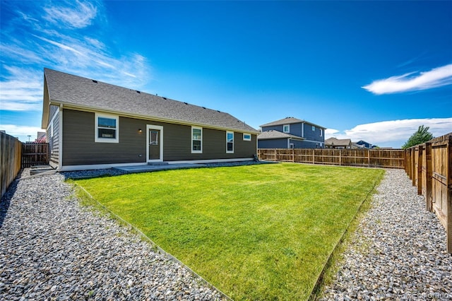 rear view of house with a yard