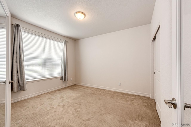 56459 E 23rd Pl, Strasburg, CO 80136 - unfurnished bedroom featuring light carpet and a textured ceiling