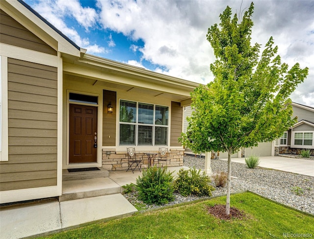 56459 E 23rd Pl, Strasburg, CO 80136 - entrance to property with driveway, stone siding, and a porch