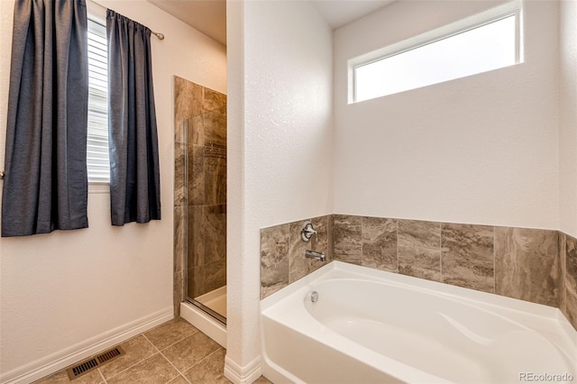 56459 E 23rd Pl, Strasburg, CO 80136 - bathroom with a garden tub, a stall shower, and tile patterned floors