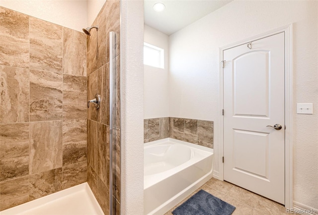 56459 E 23rd Pl, Strasburg, CO 80136 - bathroom featuring a bath, a tile shower, and tile patterned floors