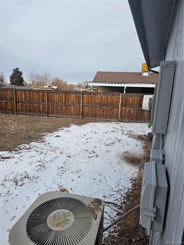 yard layered in snow with central AC