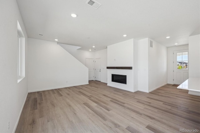unfurnished living room featuring recessed lighting, light wood finished floors, and visible vents
