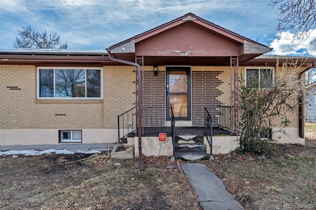 view of front of home with solar panels and brick siding