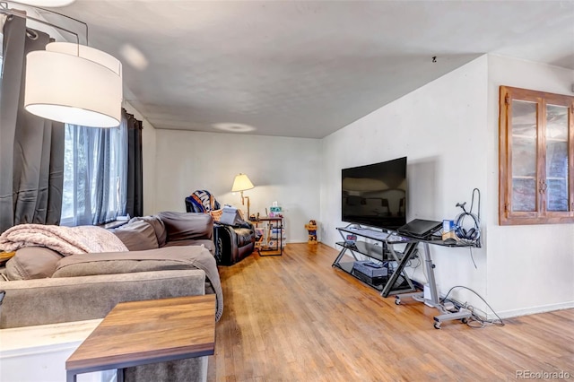 living room with baseboards and wood finished floors