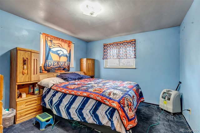 bedroom with dark colored carpet