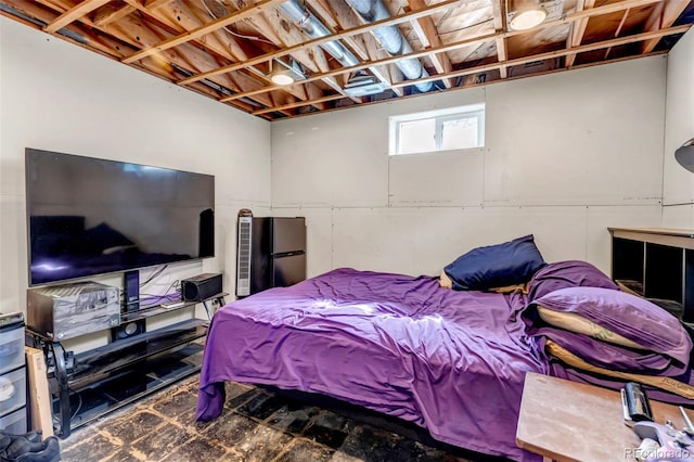 bedroom with freestanding refrigerator