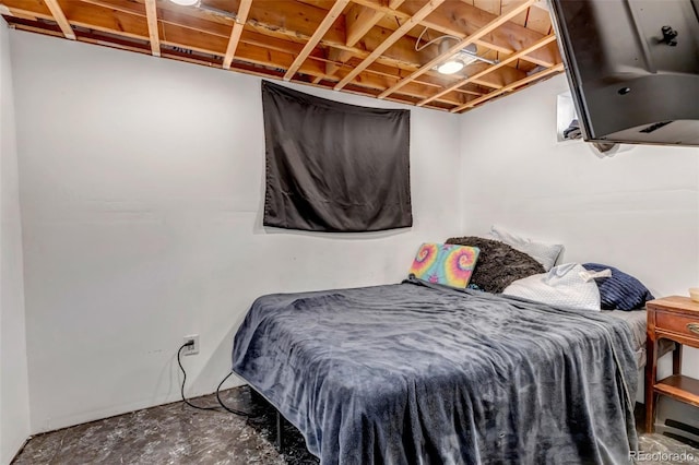 bedroom with unfinished concrete flooring