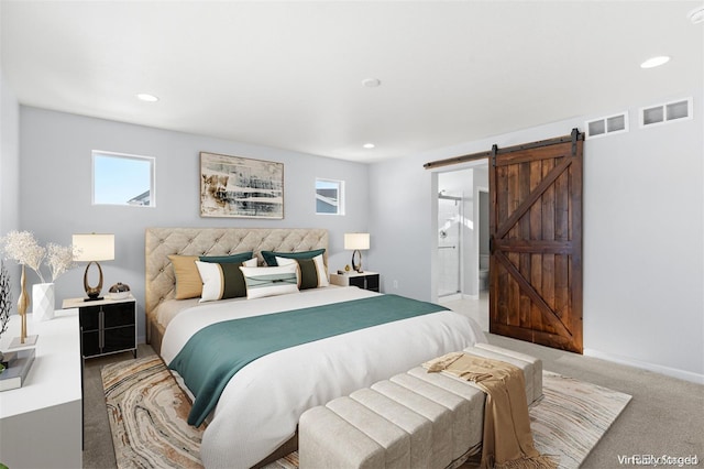 bedroom featuring a barn door and carpet flooring