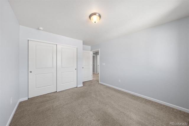 unfurnished bedroom featuring a closet and carpet flooring