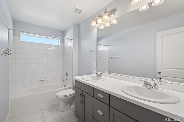 full bathroom with vanity, tile patterned floors, tiled shower / bath combo, and toilet