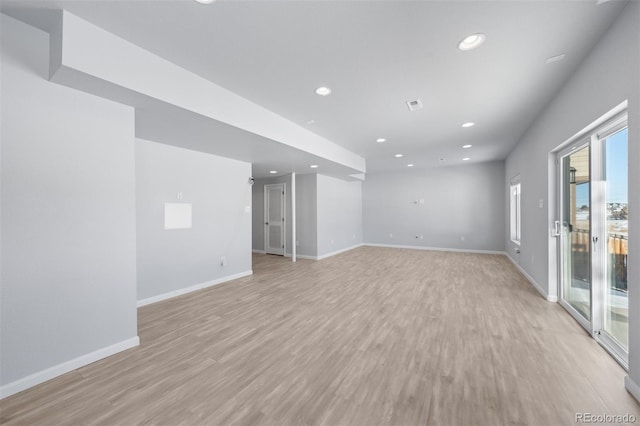 empty room with light hardwood / wood-style flooring