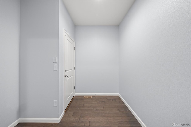 hall with dark hardwood / wood-style flooring