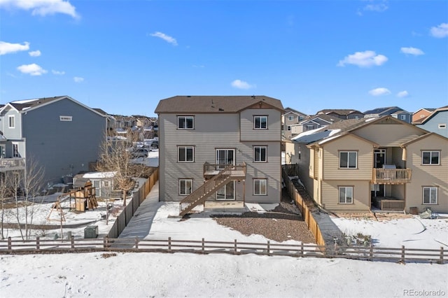 view of snow covered rear of property