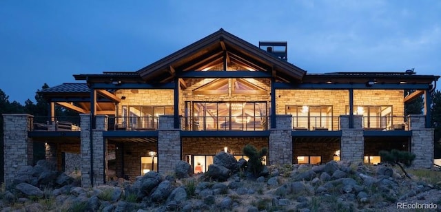 rear view of house featuring a balcony