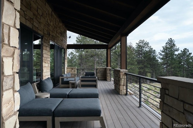 wooden terrace with an outdoor living space