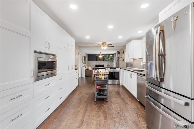 915 Mercury Cir, Littleton, CO 80124 - kitchen with appliances with stainless steel finishes, open floor plan, recessed lighting, tasteful backsplash, and dark wood finished floors
