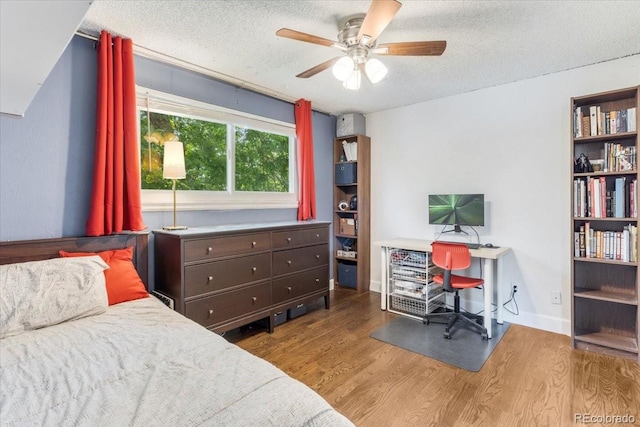 915 Mercury Cir, Littleton, CO 80124 - bedroom featuring wood finished floors, a textured ceiling, an office area, and ceiling fan