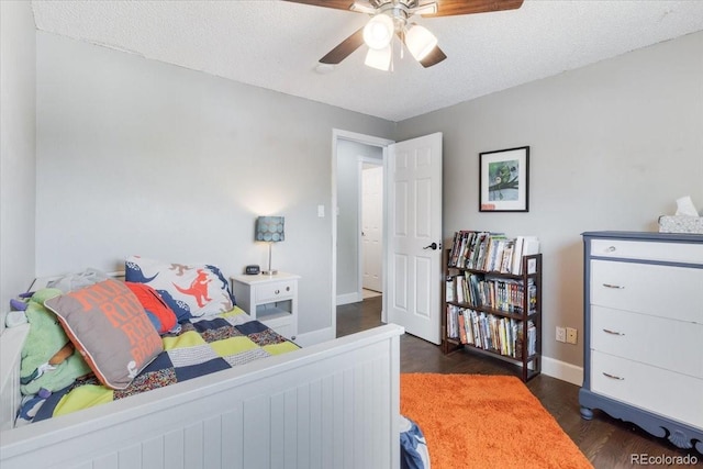 915 Mercury Cir, Littleton, CO 80124 - bedroom with dark wood finished floors, baseboards, a textured ceiling, and a ceiling fan