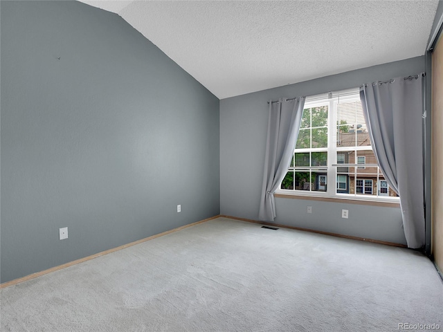 2627 E Nichols Cir, Centennial, CO 80122 - carpeted empty room with vaulted ceiling, baseboards, and a textured ceiling