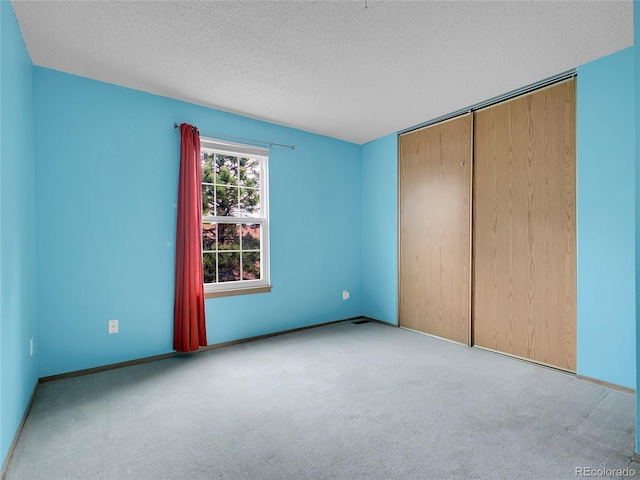 2627 E Nichols Cir, Centennial, CO 80122 - unfurnished bedroom with a textured ceiling, carpet floors, a closet, and baseboards