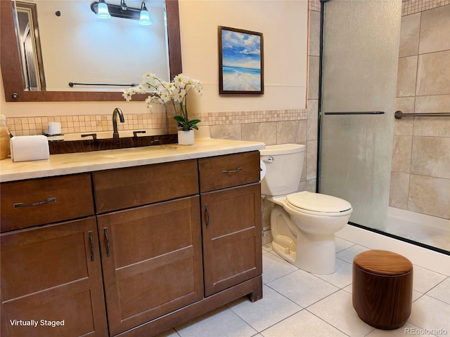 390 Zang St Unit 5-102, Lakewood, CO 80228 - bathroom featuring walk in shower, toilet, tile walls, vanity, and tile patterned flooring