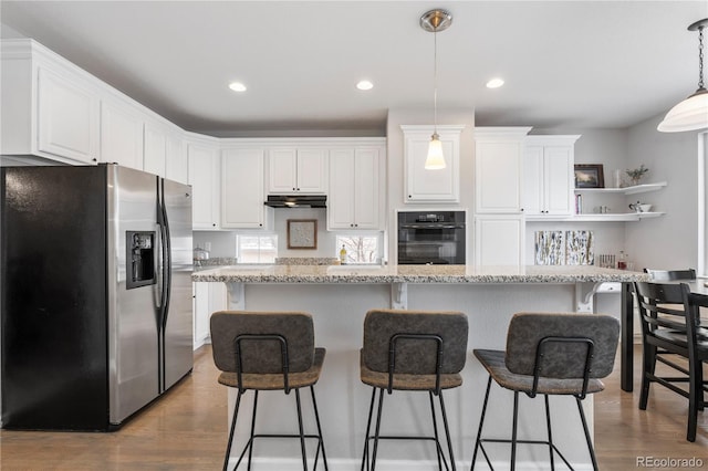 kitchen with white cabinets, wood finished floors, stainless steel refrigerator with ice dispenser, and under cabinet range hood