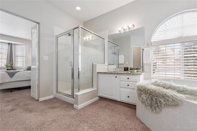 bathroom featuring vanity, carpet, ensuite bath, and a shower stall