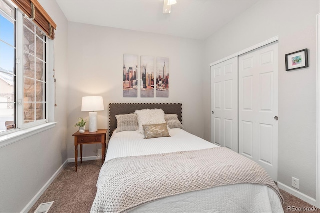 carpeted bedroom featuring a closet, visible vents, ceiling fan, and baseboards