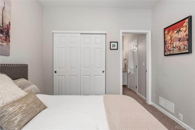 carpeted bedroom with baseboards, visible vents, and a closet