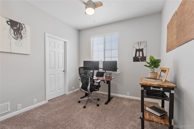 carpeted office space with visible vents, baseboards, and ceiling fan