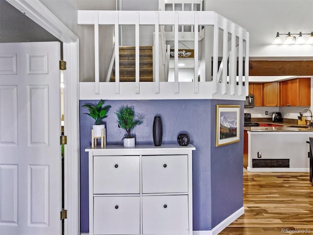 kitchen featuring sink, stainless steel electric range oven, and light hardwood / wood-style floors