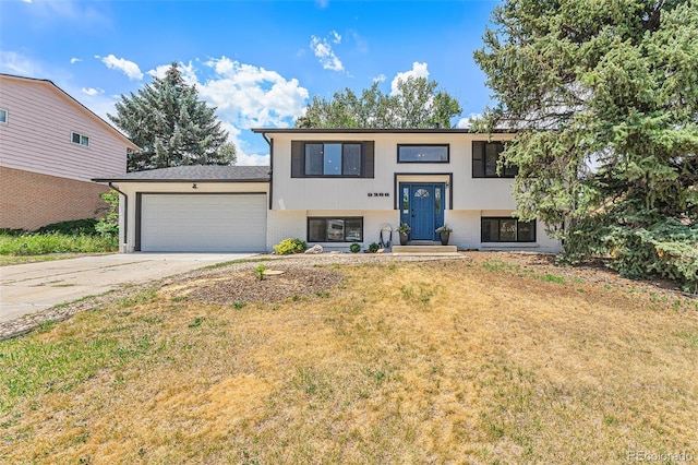 9265 Newton St, Westminster, CO 80031 - bi-level home with an attached garage, driveway, and a front lawn