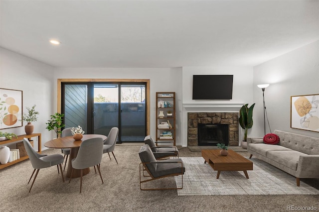 living room with light colored carpet and a stone fireplace