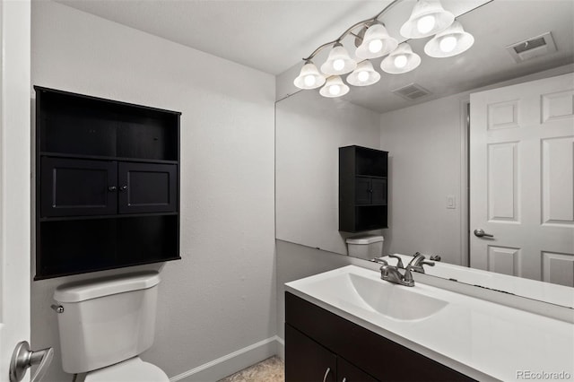 bathroom featuring toilet and vanity