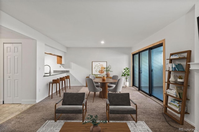 dining room featuring recessed lighting, light colored carpet, and baseboards