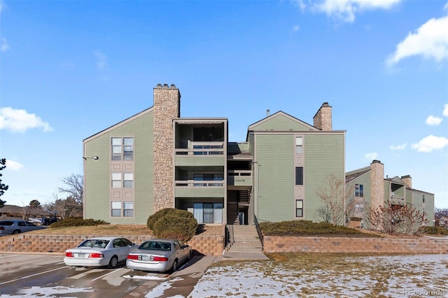 view of property featuring uncovered parking