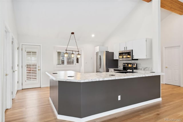 1904 S Union Pl, Lakewood, CO 80228 - kitchen with appliances with stainless steel finishes, a peninsula, high vaulted ceiling, white cabinets, and light wood-type flooring