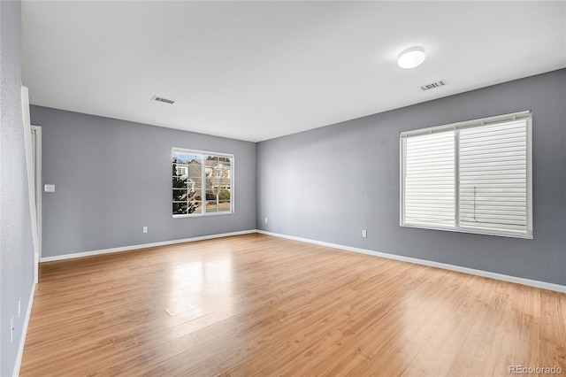 unfurnished room with light hardwood / wood-style floors