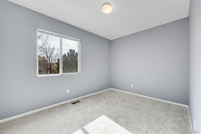 spare room with light colored carpet