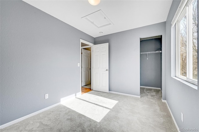 unfurnished bedroom with light carpet and a closet