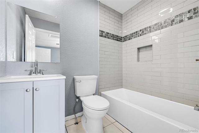 full bathroom with vanity, tiled shower / bath, tile patterned floors, and toilet