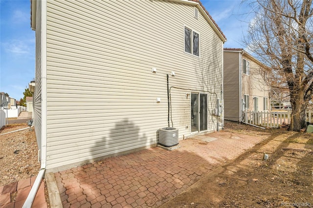 rear view of house with cooling unit and a patio area