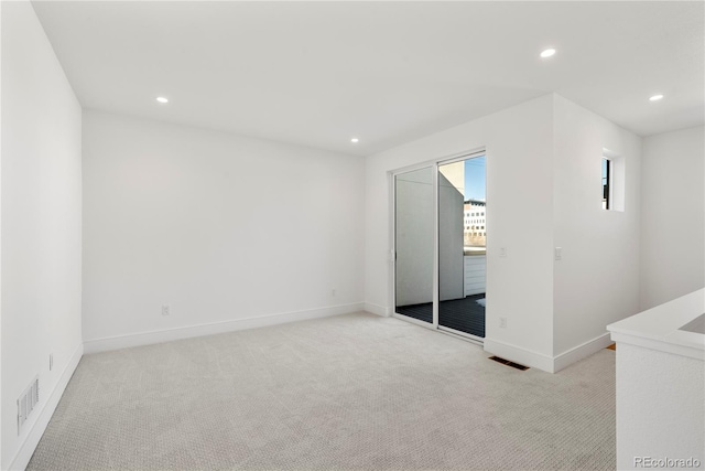 unfurnished bedroom featuring access to exterior and light colored carpet