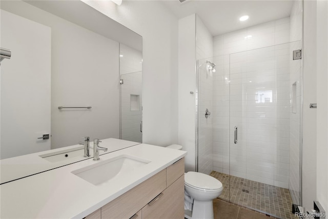 bathroom featuring tile patterned floors, vanity, an enclosed shower, and toilet