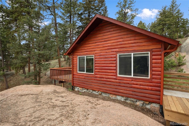 481 Arrowhead, Florissant, CO 80816 - view of side of home featuring a deck and faux log siding