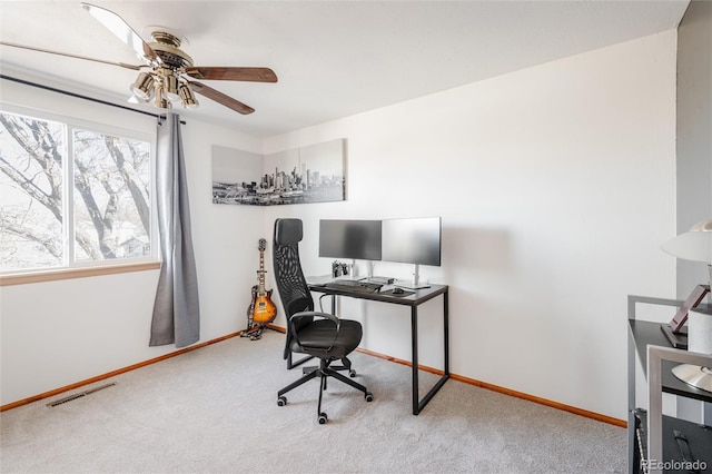 carpeted office space with ceiling fan