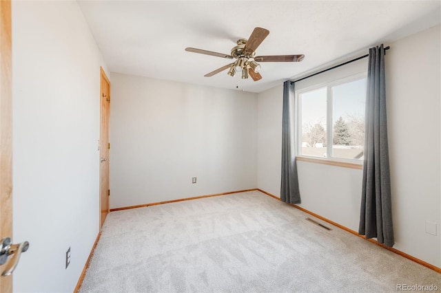 carpeted spare room featuring ceiling fan