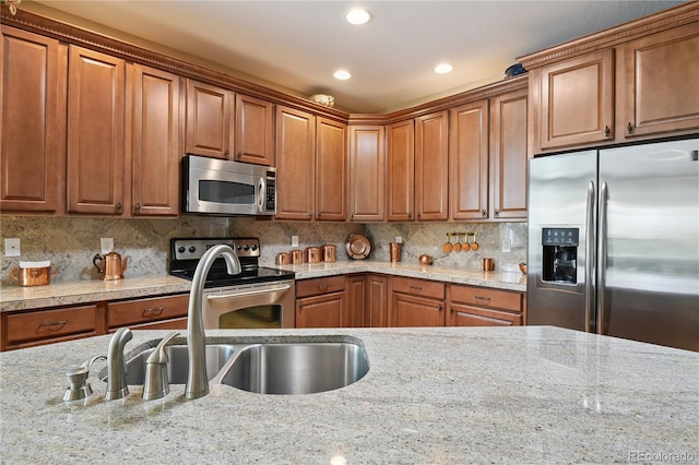 23285 Chapel Hill Ln, Parker, CO 80138 - kitchen with stainless steel appliances, recessed lighting, brown cabinetry, and light stone countertops
